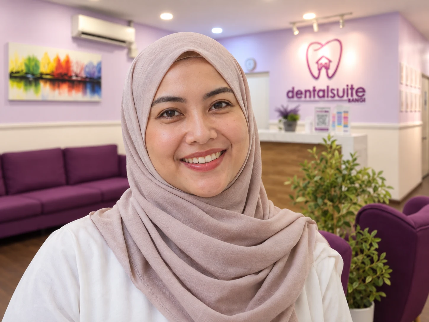 Smiling woman in a hijab at the Dental Suite Bangi clinic (illustrative photo).